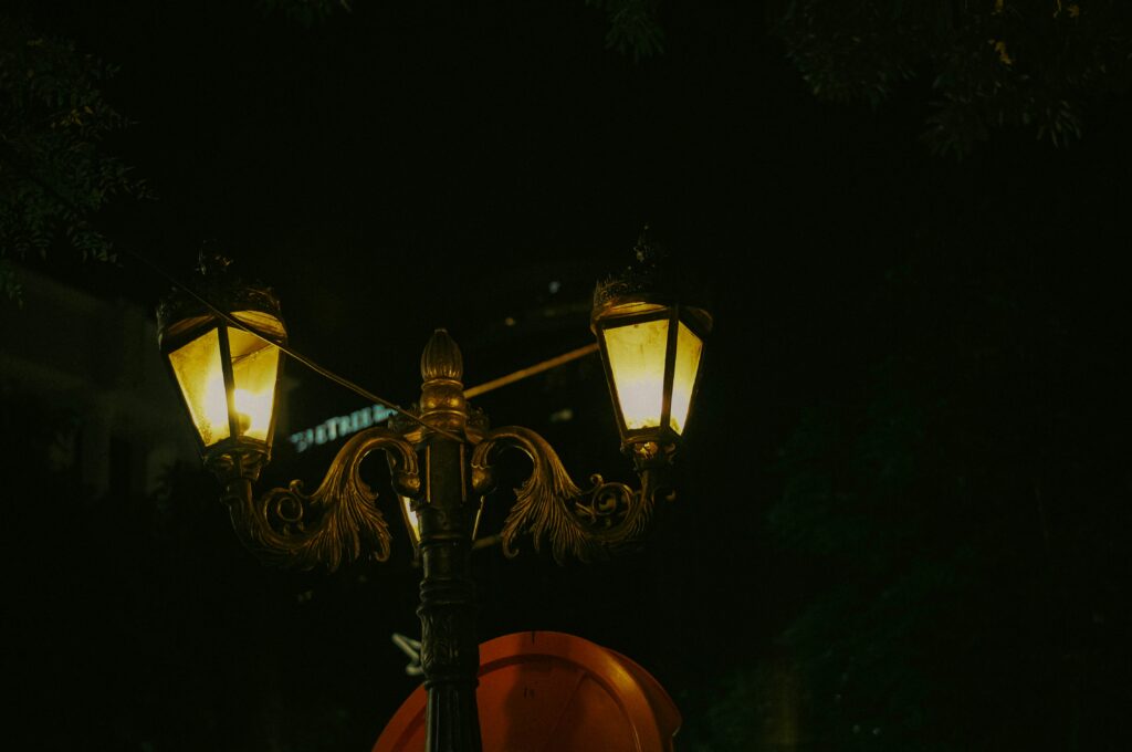 Lanterns lined the streets of a hot spring resort at night and people walking around in yukata (light cotton kimono)